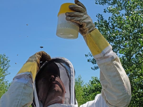 a man looks at a plastic container