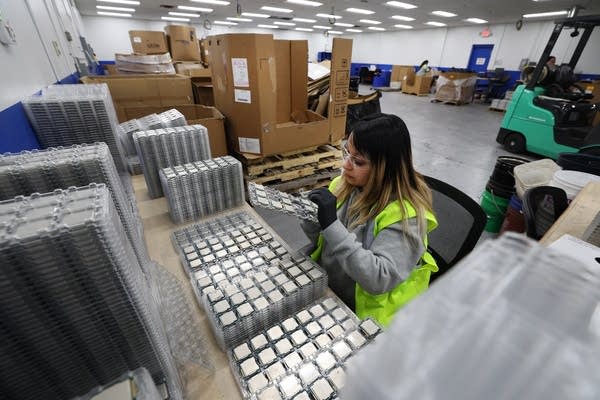 Naila Pina sorts through trays of computer processors