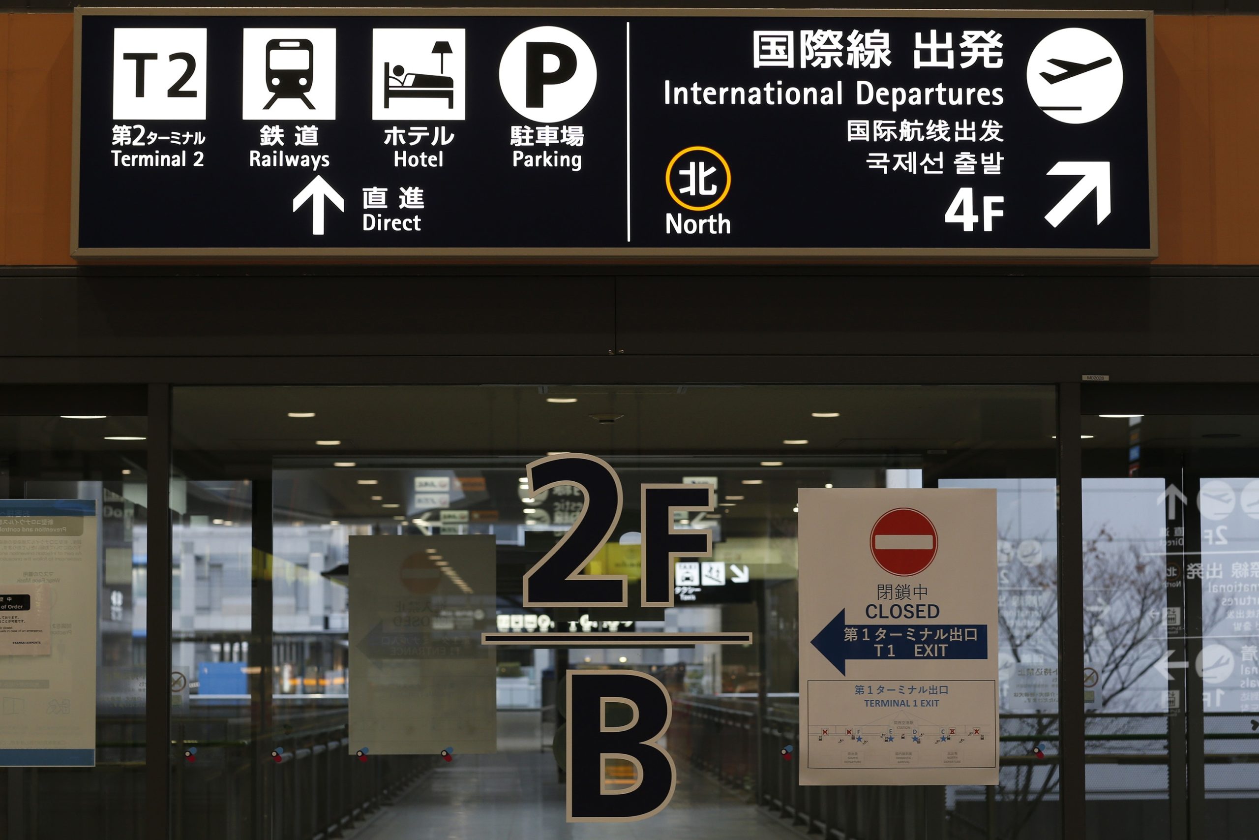 A closed sign is pasted to passengers entrance door to departure hall at Kansai International Airport.