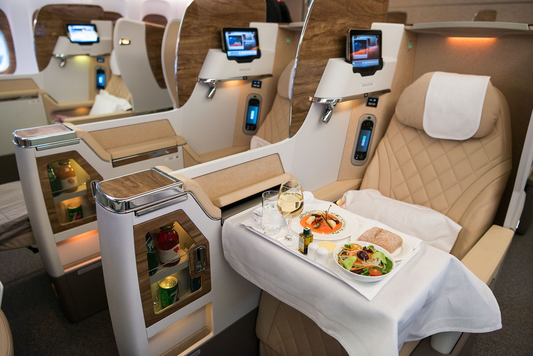 Emirates business class seats on the Boeing 777-300 ER with a meal on the tray table.