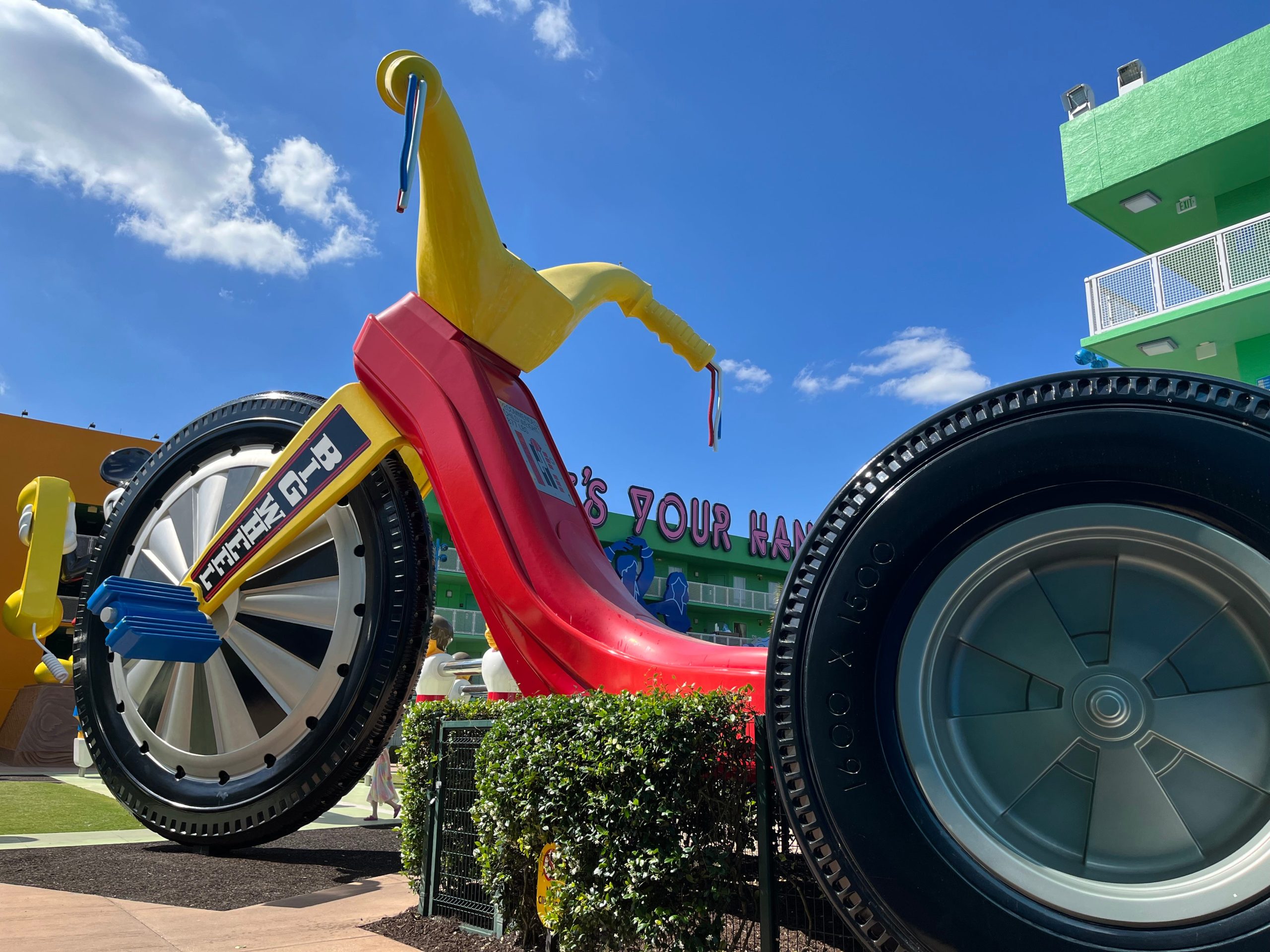 big tricycle in the middle of the grounds at pop century in disney world