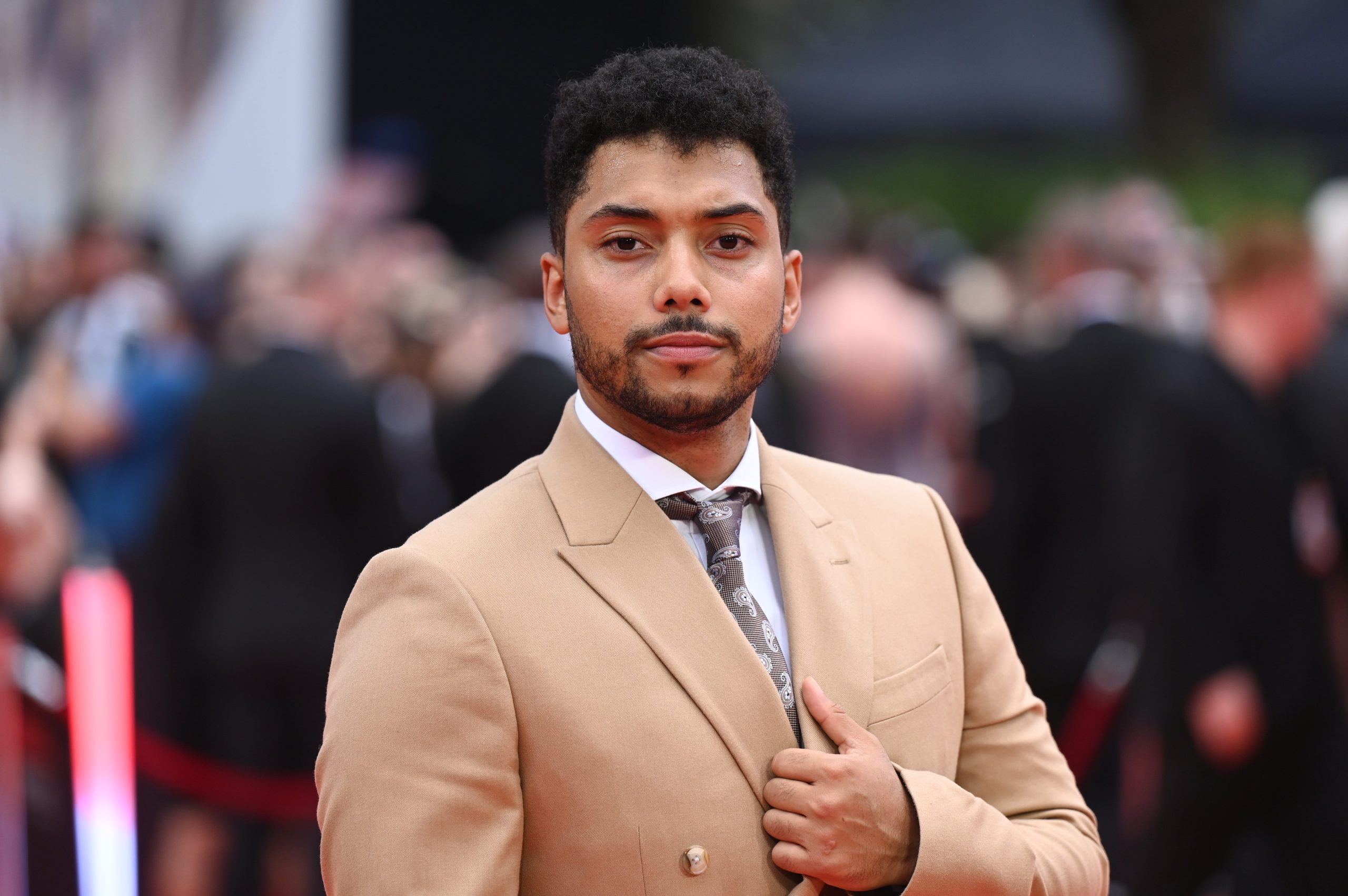 Chance Perdomo in a cream jacket