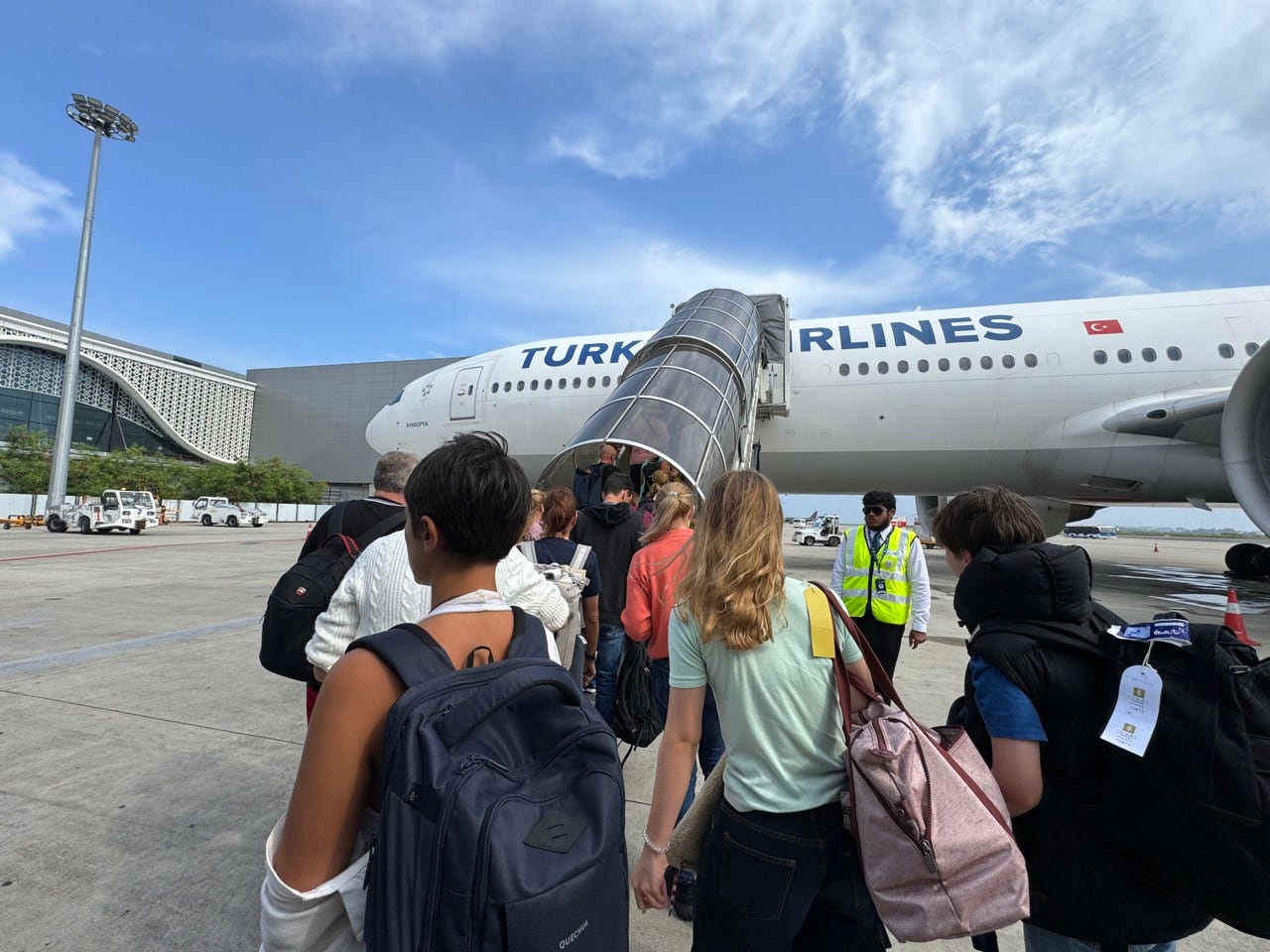 Group of people boarding Turkish Airlines flight 