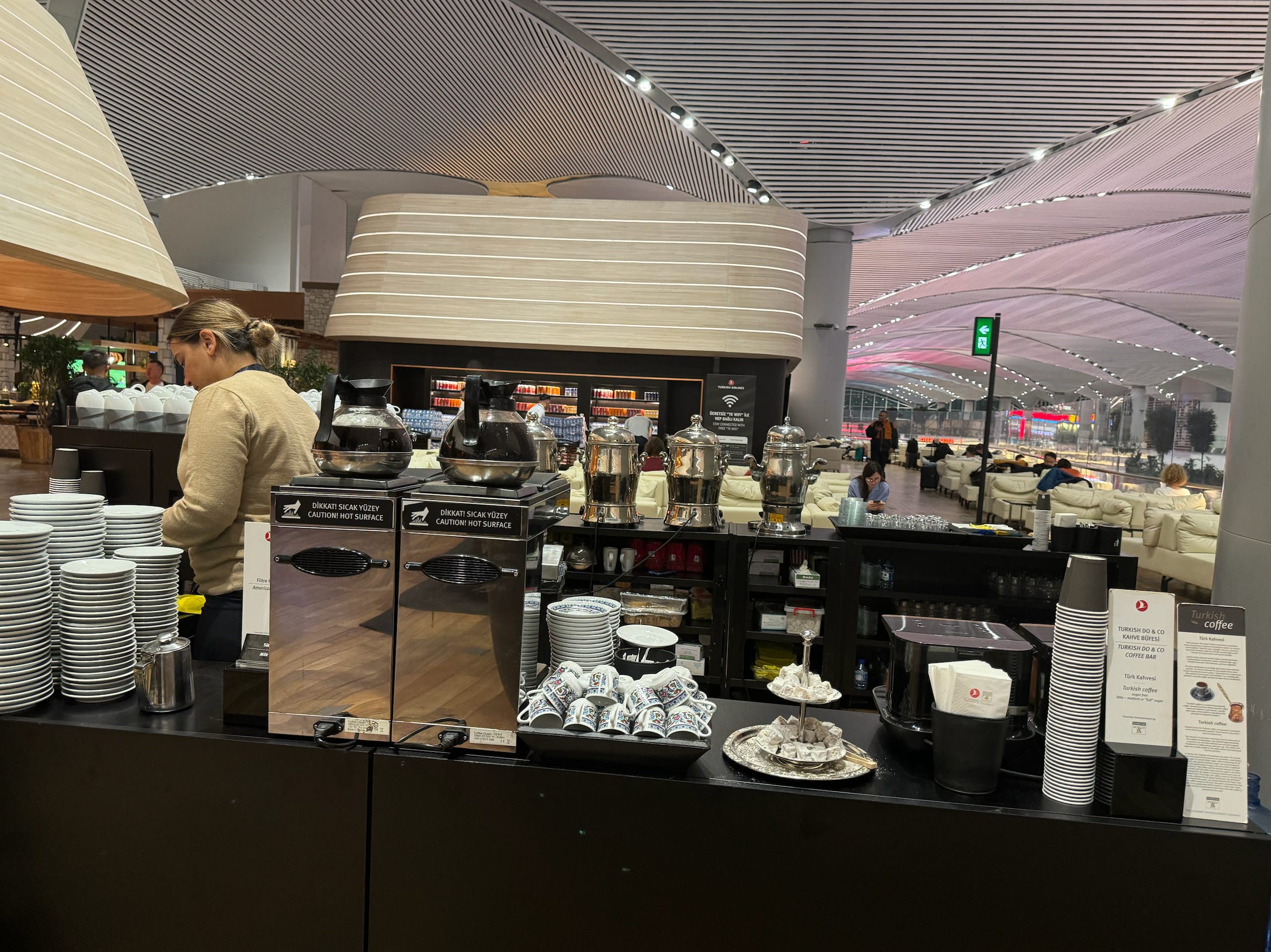 Barista behind coffee station in airport 