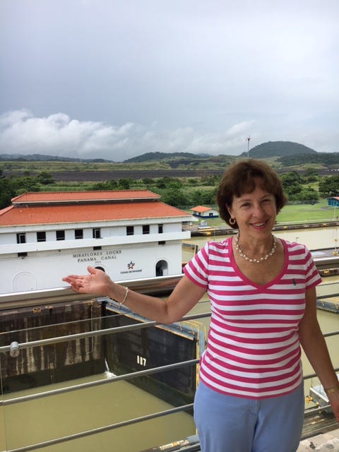 Diana Hechler smiling against the backdrop on a scenic landscape