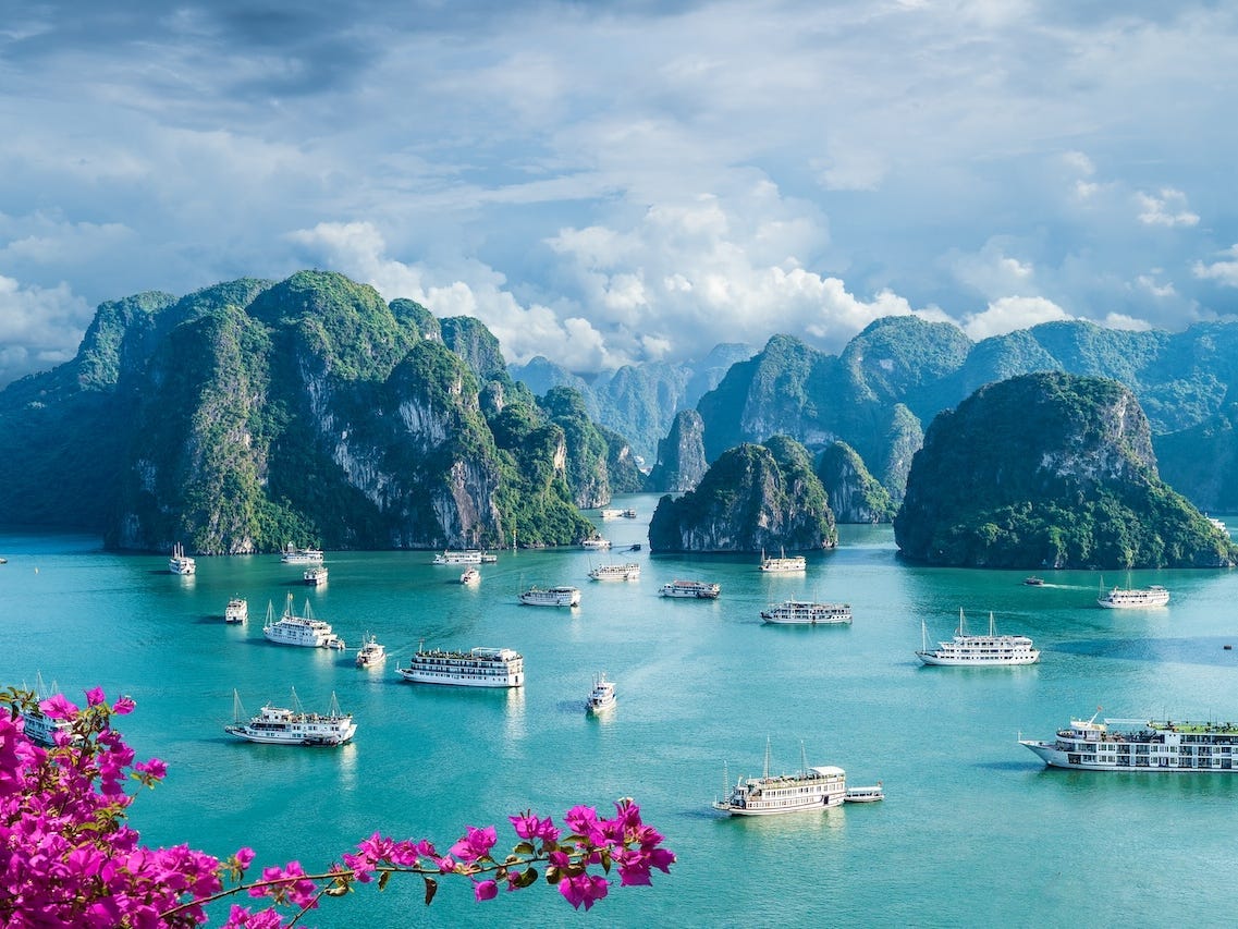 Boats float through Ha Long Bay, Vietnam.