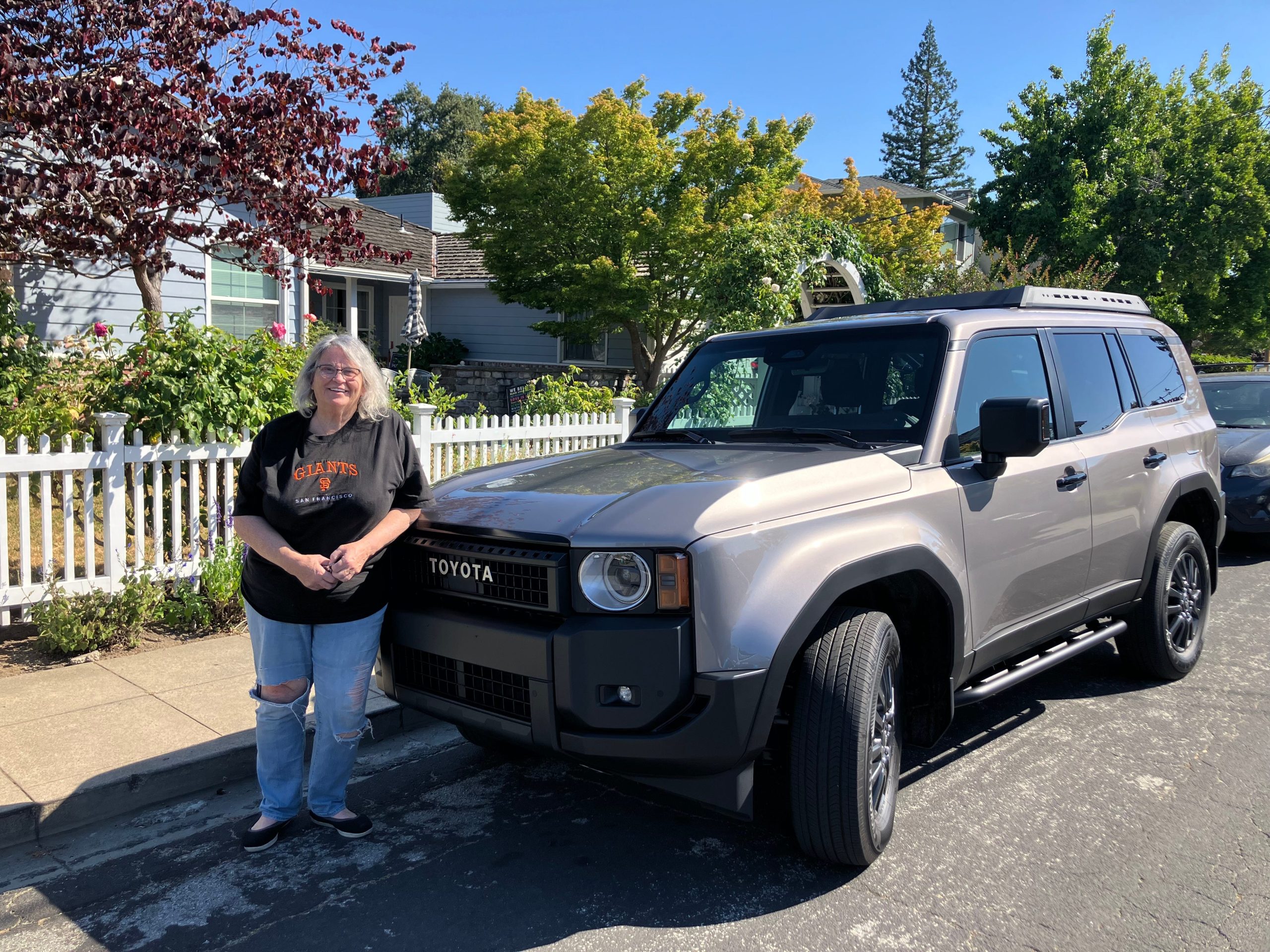 A woman stands beside a Toyota Land Cruiser in Silicon Valley