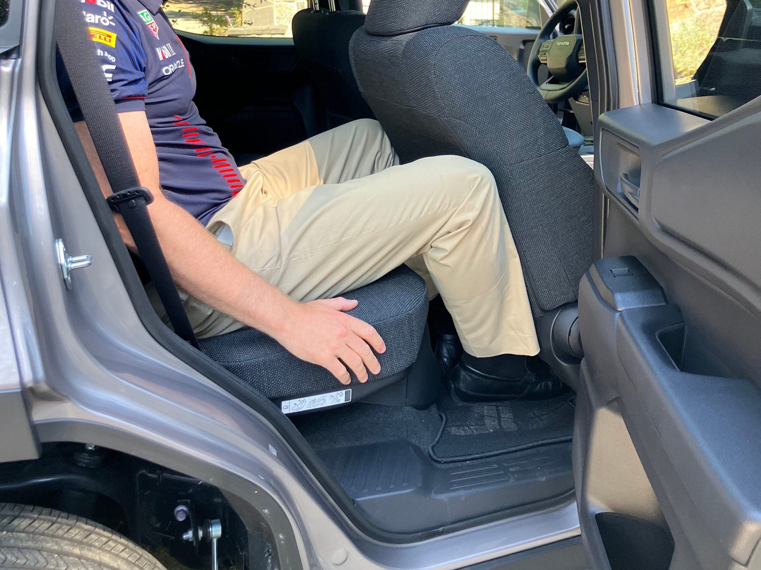 A man sits in the back of a Toyota Land Cruiser