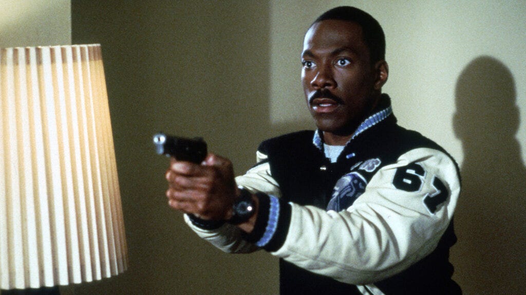 Eddie Murphy holding a gun