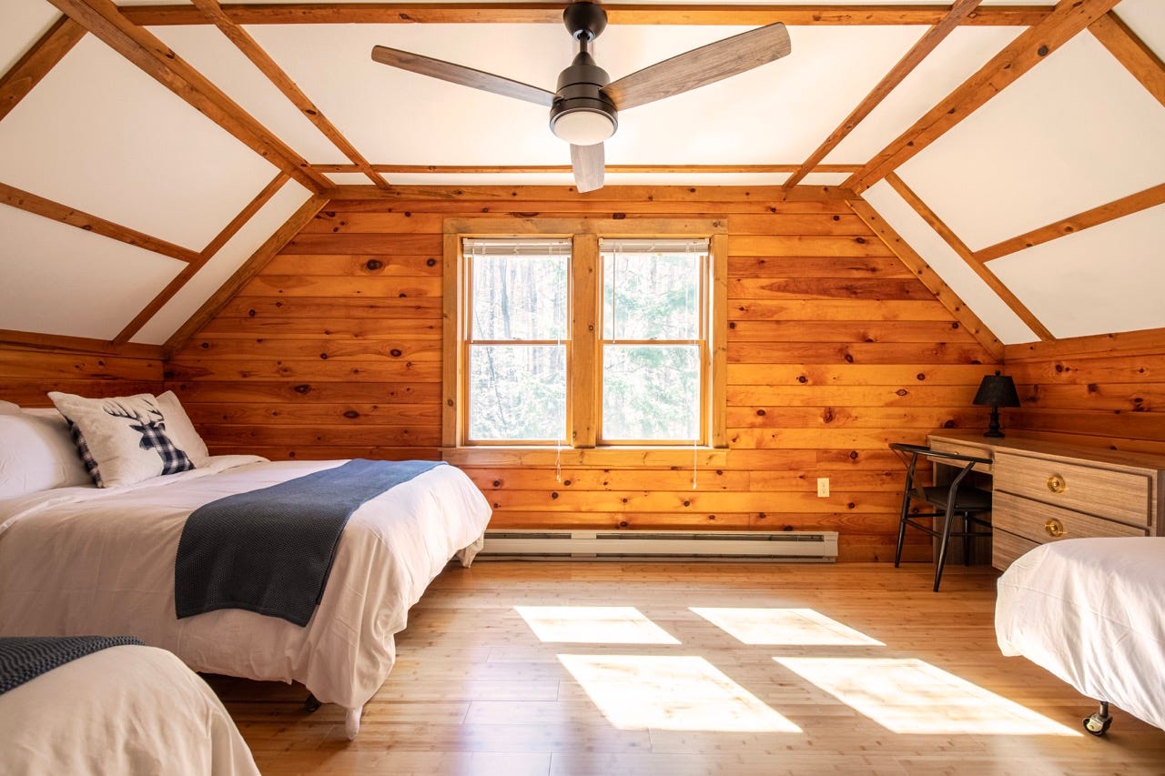 Ceiling fan in wood-paneled room 