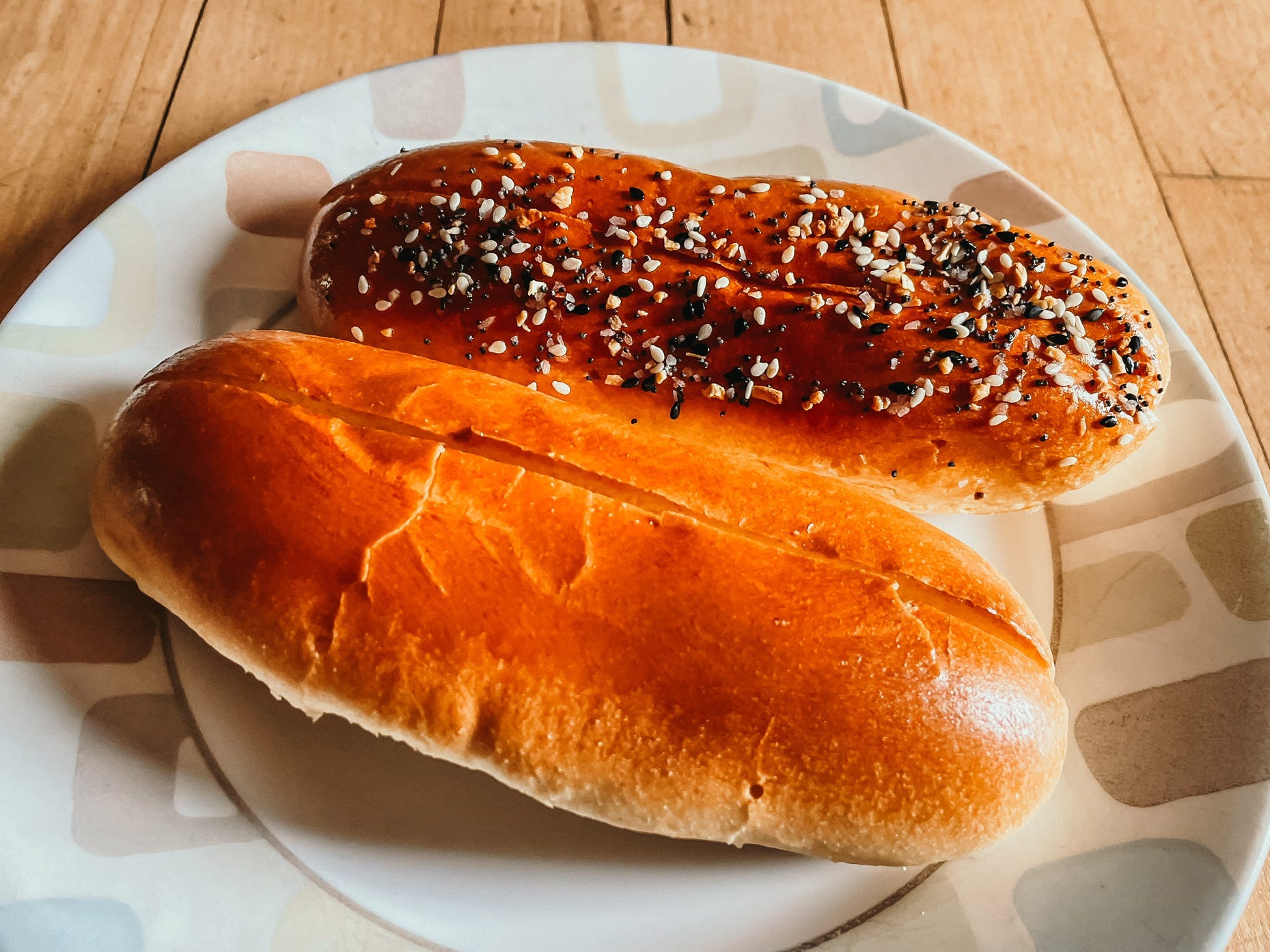 two toasted hot dog buns on a plate