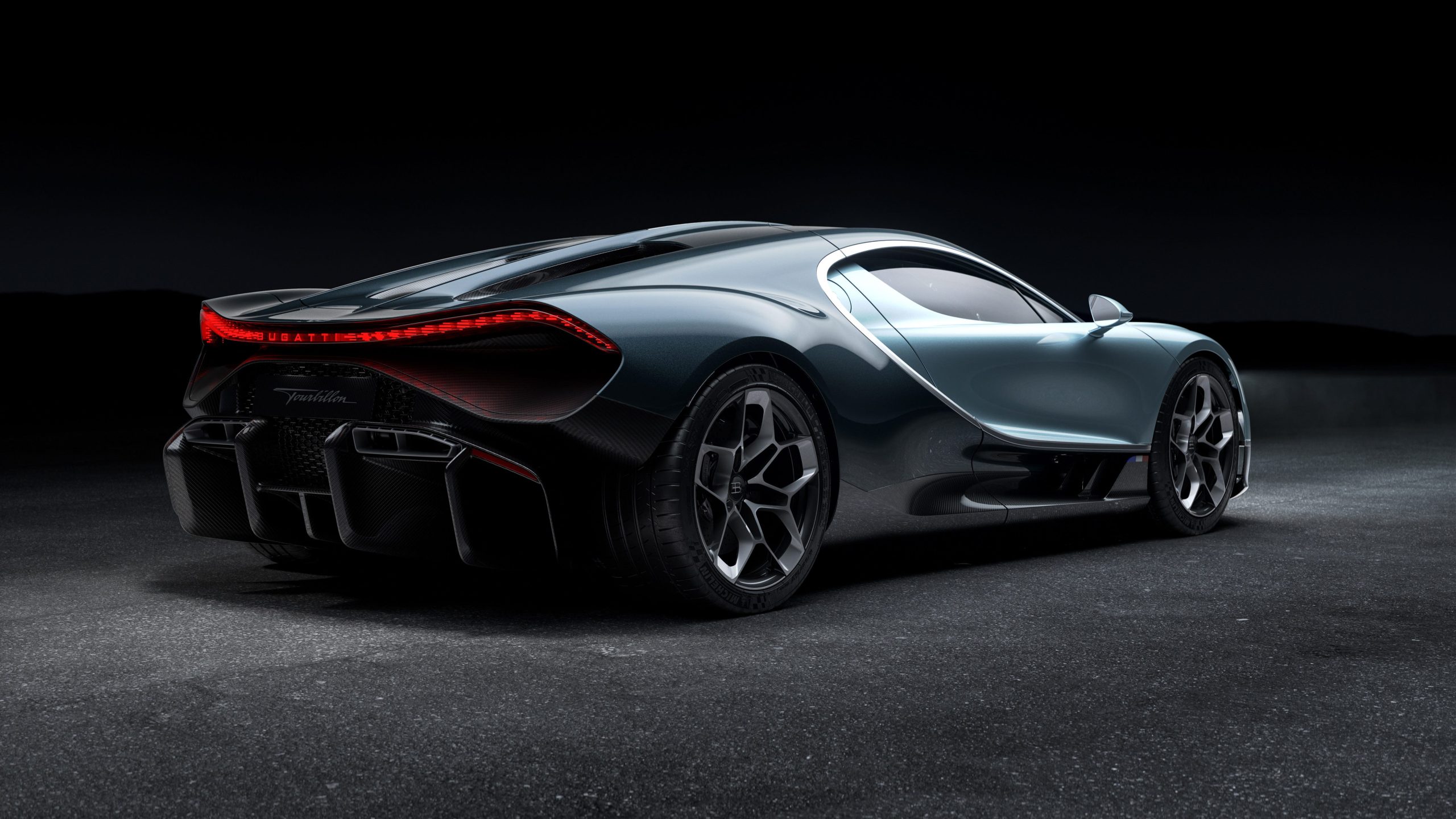 The rear end of a blue Bugatti Tourbillon hypercar.