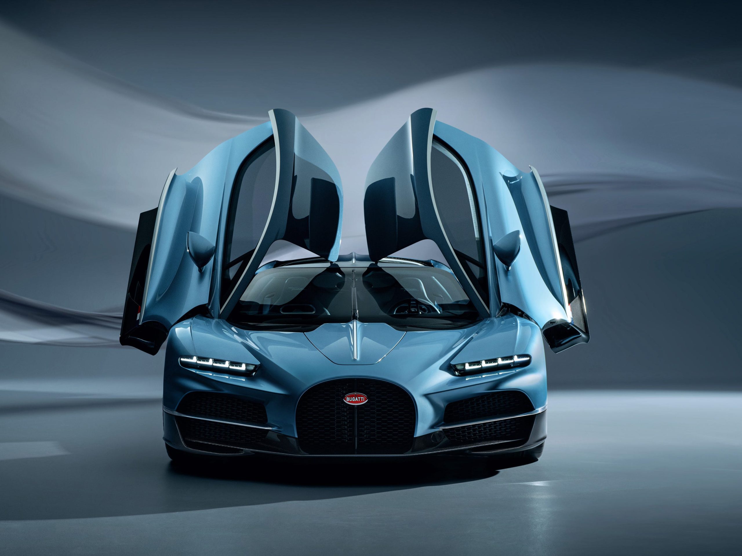 The front of a blue Bugatti Tourbillon with its doors open.