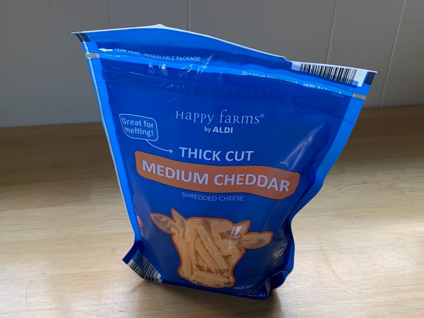 bag of shredded cheddar cheese on a kitchen counter