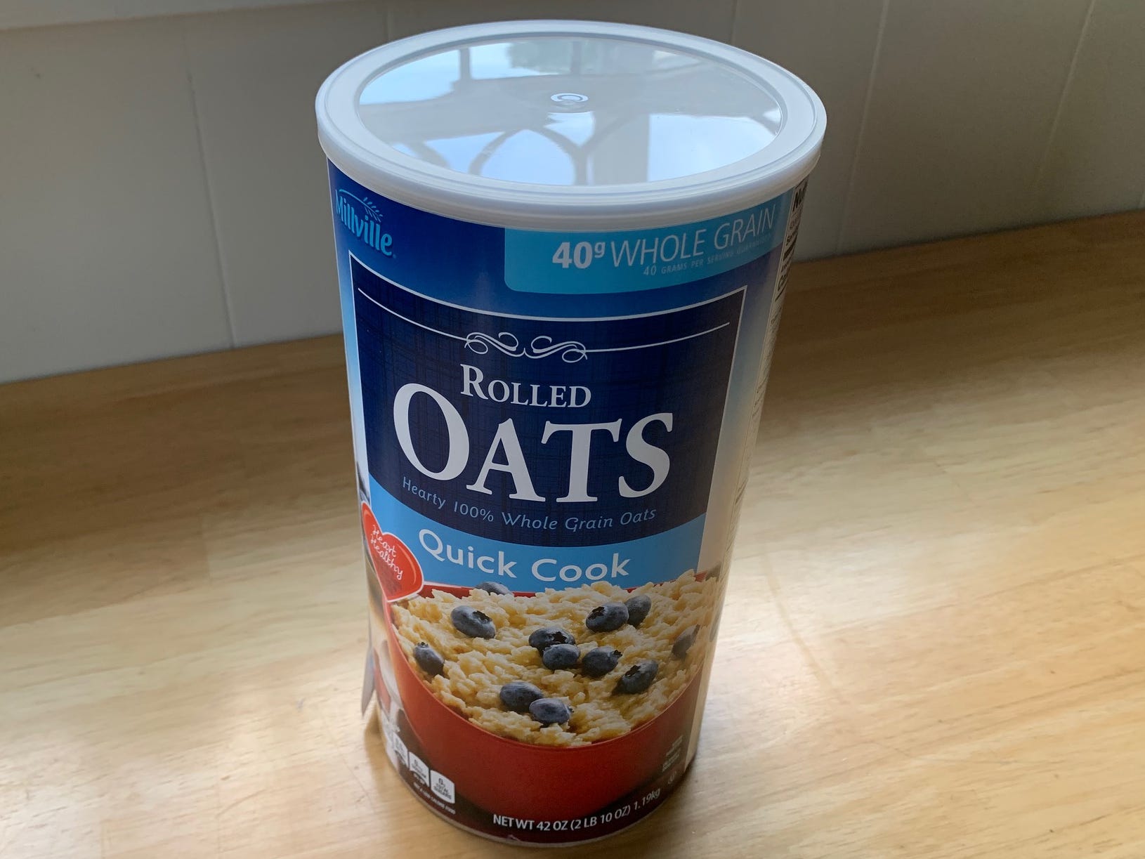 large container of oats on a kitchen counter