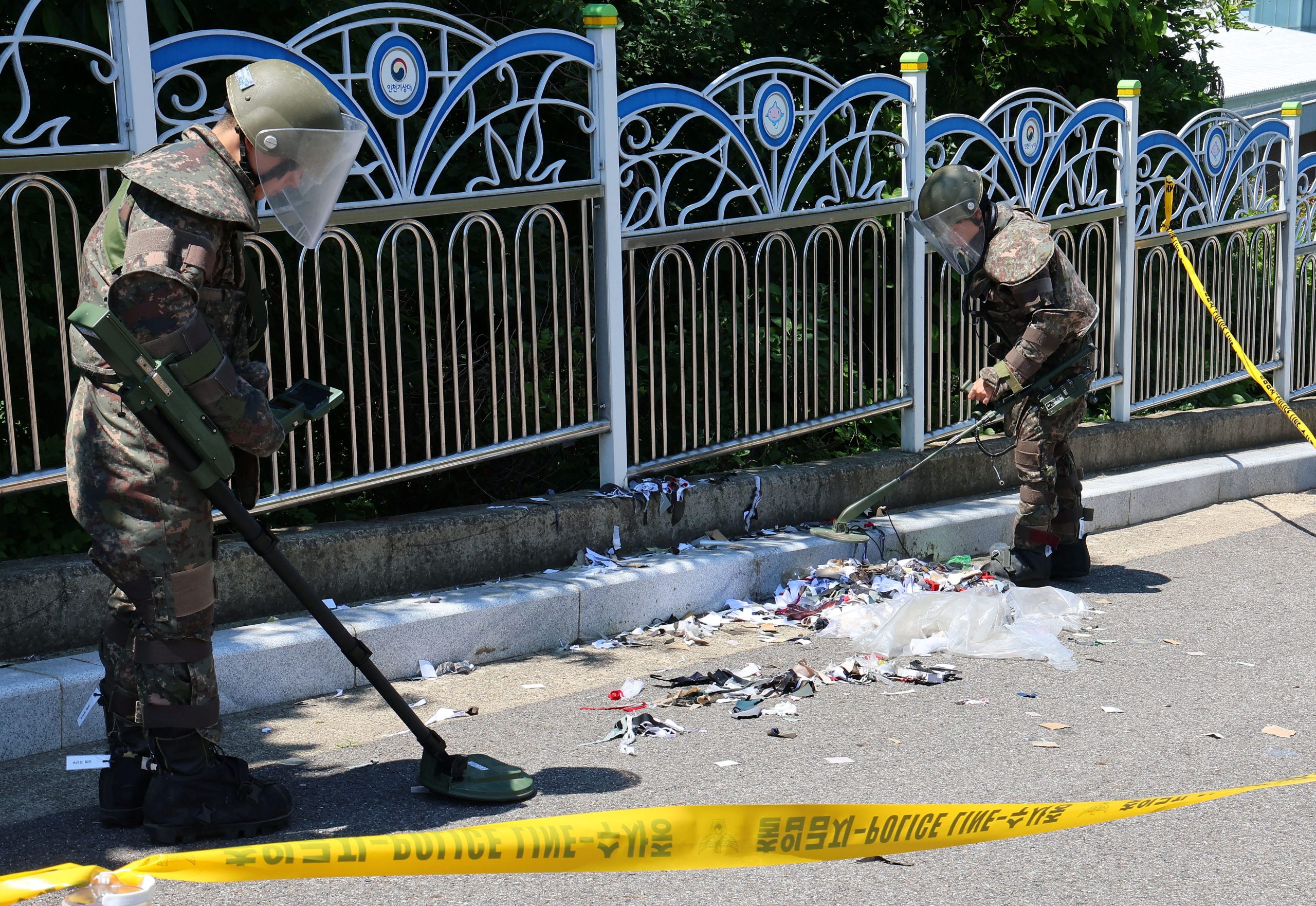 soldiers examine various objects