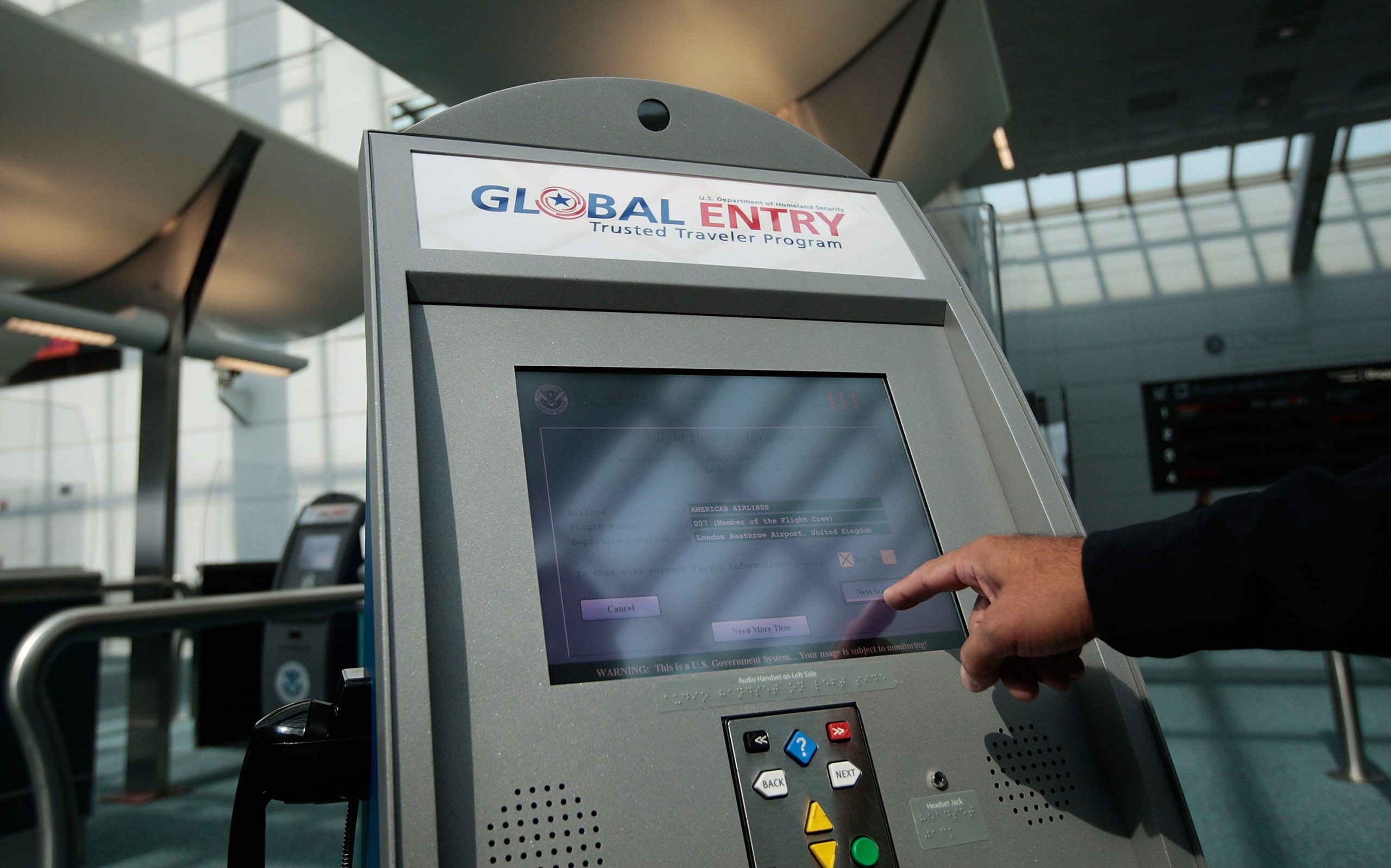 : An officer with the US Customs and Border Protection demonstrates a new arrivals processing kiosk