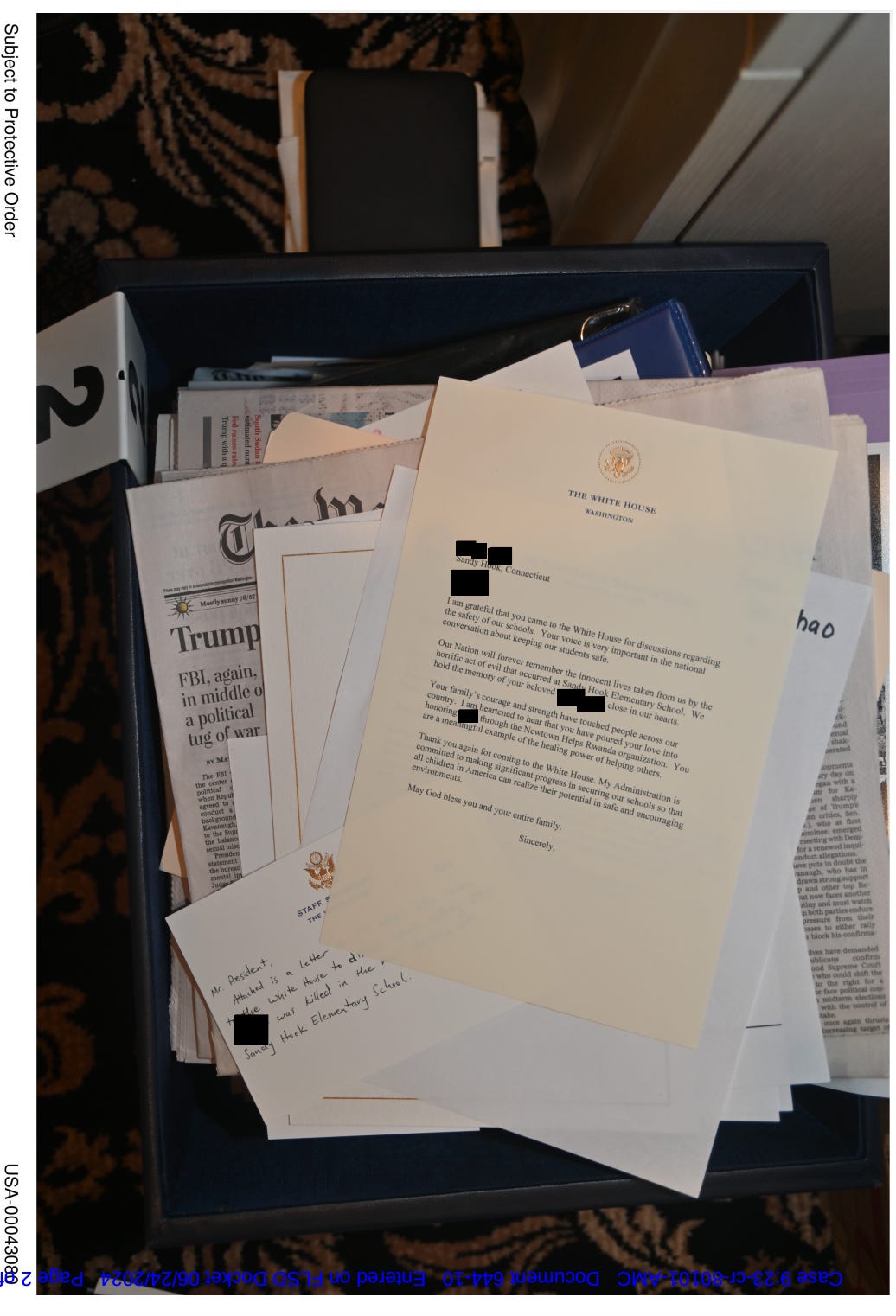 This evidence photo from the Mar-a-Lago classified documents case shows a letter Donald Trump sent in 2018 to the older brother of a Sandy Hook shooting victim.