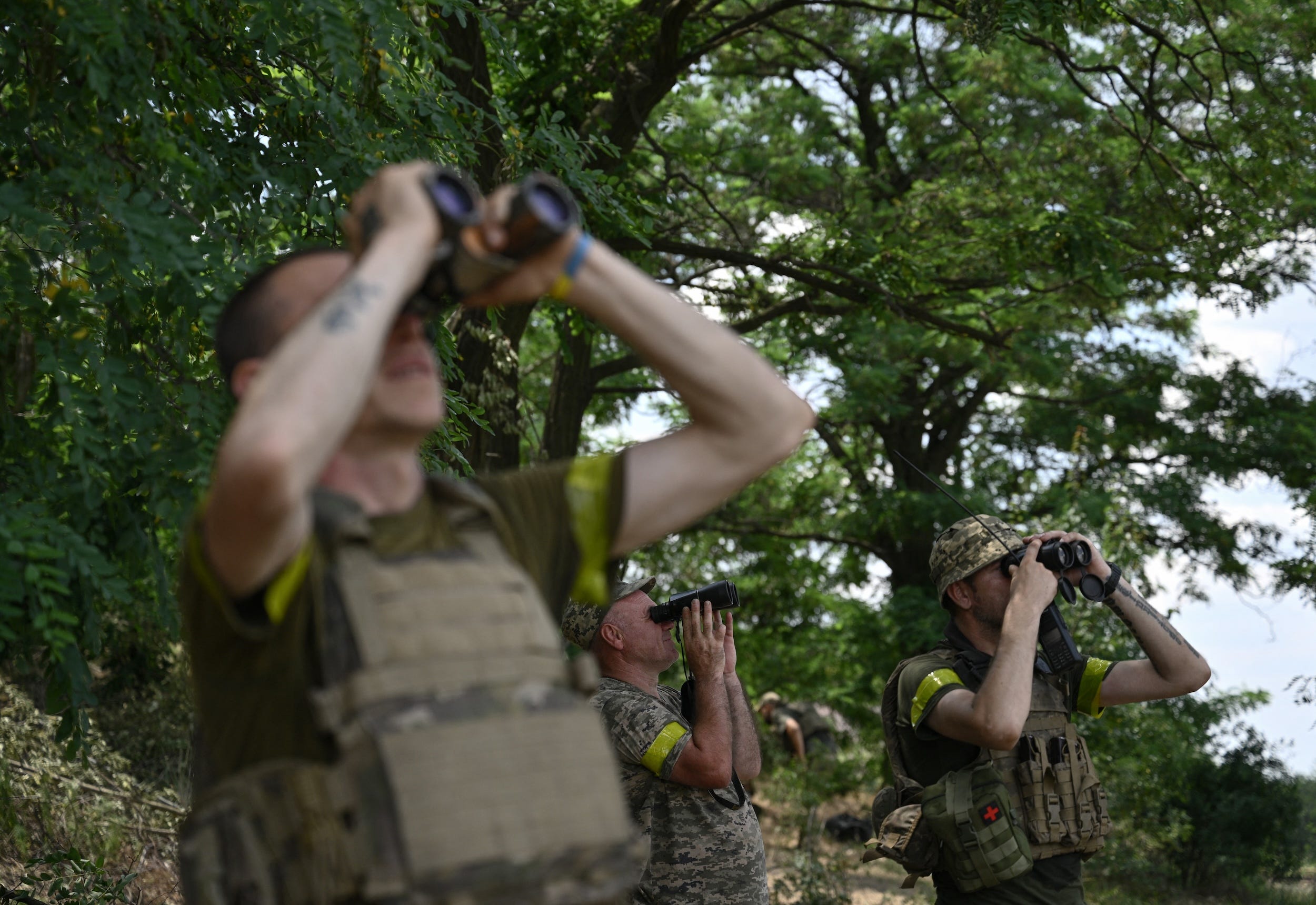 Ukrainian servicemen scan the sky for Russian drones and aircraft