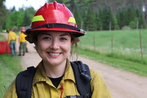 a female firefighter smiles for a portrait